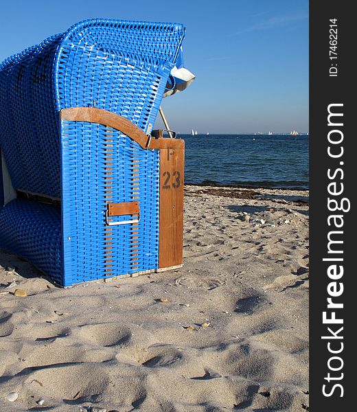 Blue hooded chair on the beach. Blue hooded chair on the beach