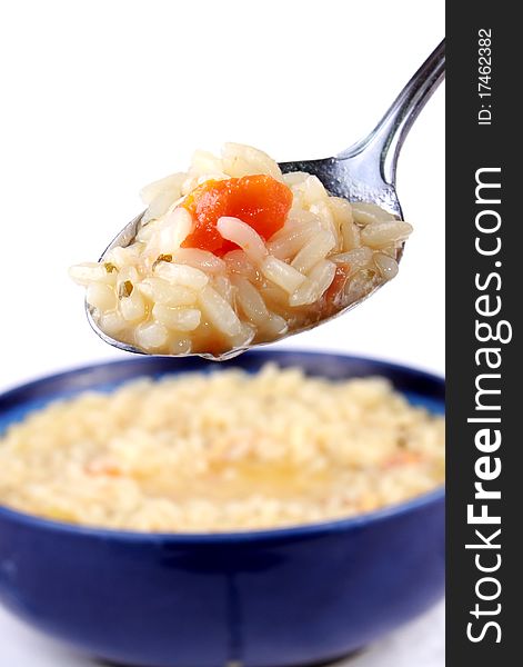 Spoon of rice with chicken and carrots