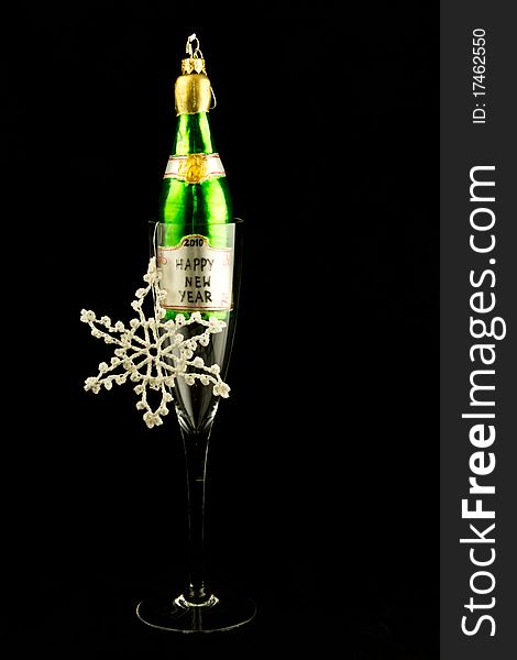 This is an image of a champagne bottle inside a champagne flute. This is an image of a champagne bottle inside a champagne flute.