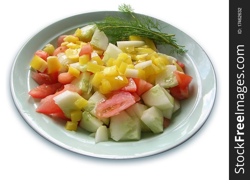 The plateful of fresh vegetable salad (cucumber, pepper, cucumber, dill).