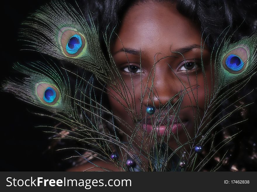 A African American woman with peacock feathers. A African American woman with peacock feathers