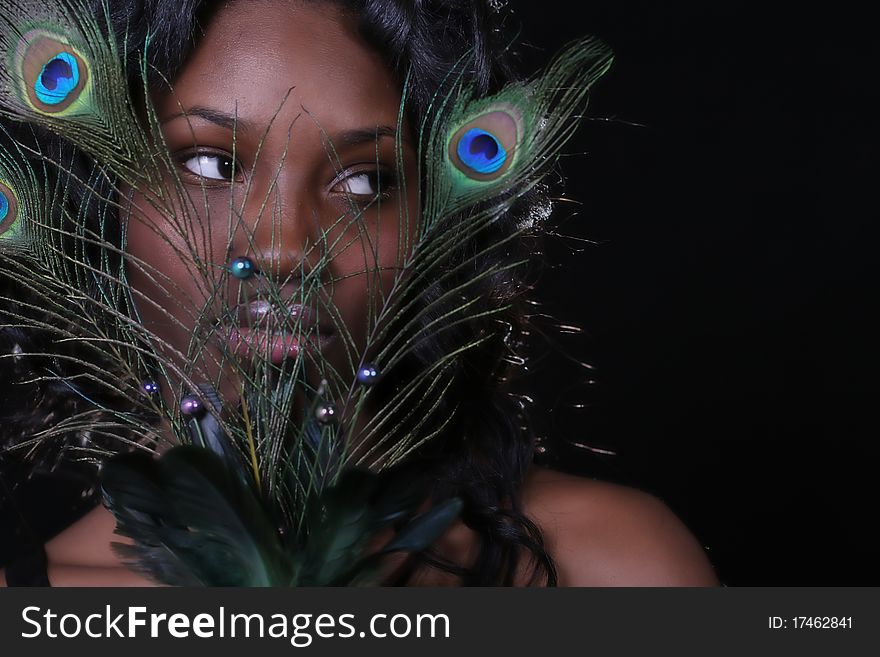 A African American woman with peacock feathers. A African American woman with peacock feathers