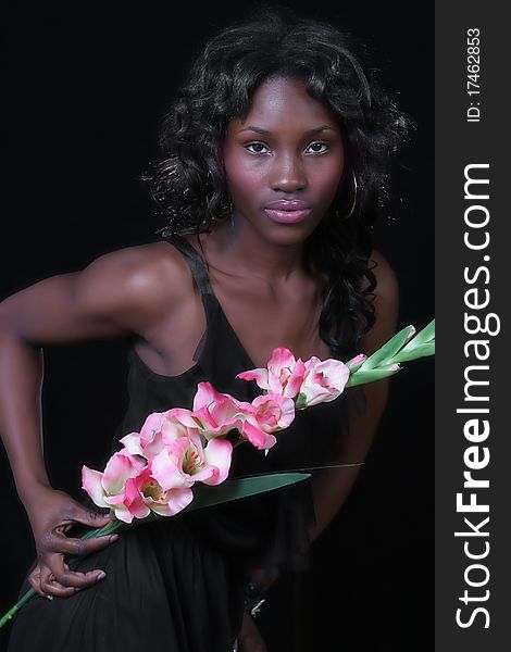 A sexy African American woman with a large flower. A sexy African American woman with a large flower