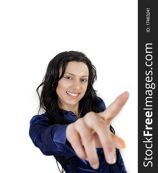 Portrait of happy young woman pointing with hand towards the camera