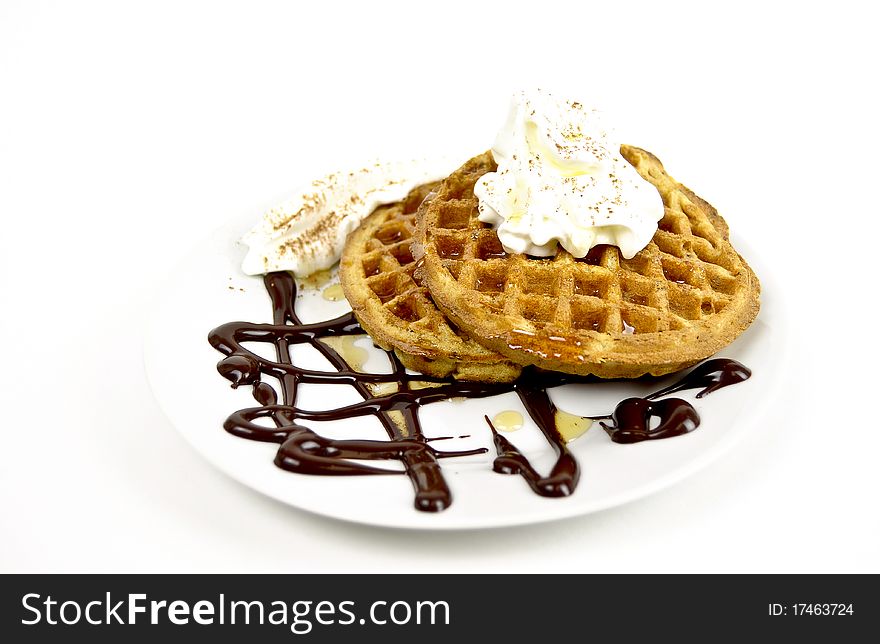Waffles breakfast  with cream  and chocolate on a white buckground