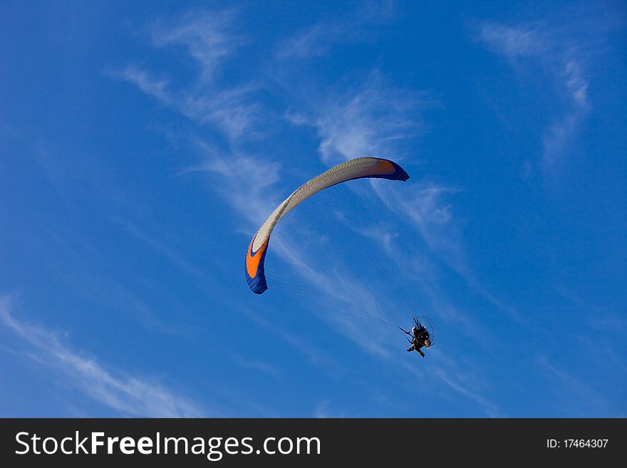 Paramotor flying in the deep blue sky during Balloon festival in Thailand.