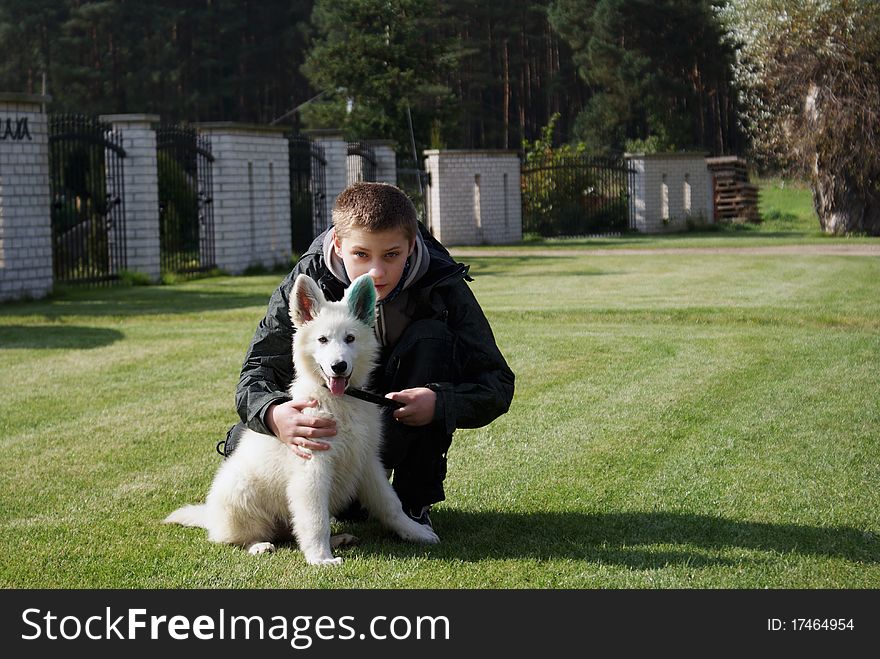 The photography of teenager with his shepherd (The Berger Blanc Suisse). Photo taken in 2010. The photography of teenager with his shepherd (The Berger Blanc Suisse). Photo taken in 2010.