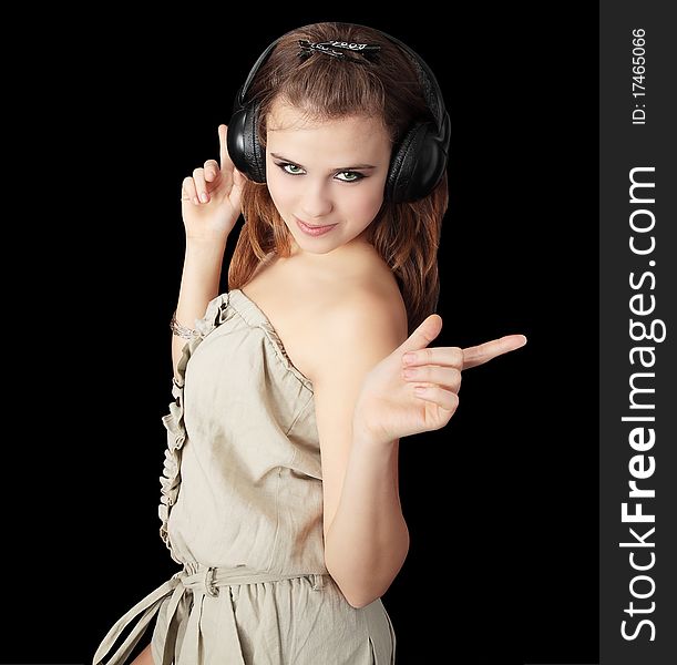 Girl in the head sets dances and indicates by the fingers
