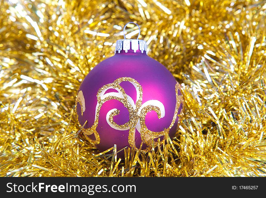 Purple christmas ball in gold decorations