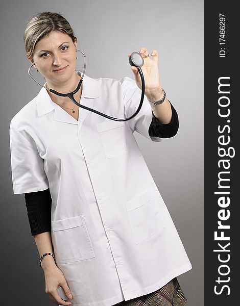 Young doctor posing with stethoscope in studio. Young doctor posing with stethoscope in studio