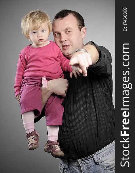 White man posing with his daughter in studio. White man posing with his daughter in studio