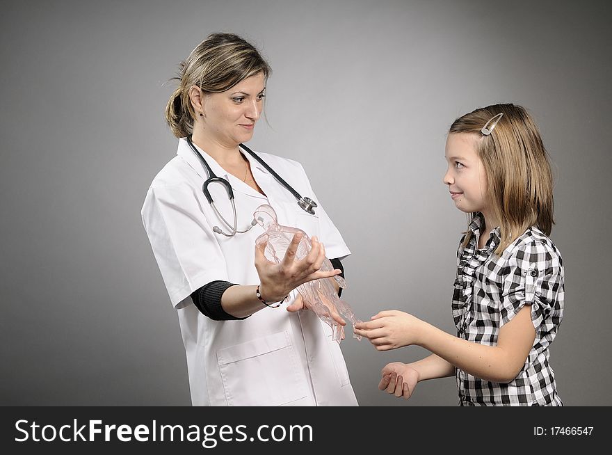 Girl learning and doctor presenting human body structure. Girl learning and doctor presenting human body structure