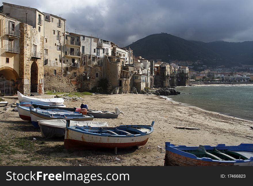 Seaside of Cefalu - old boats and architecture, Sicily, Italy