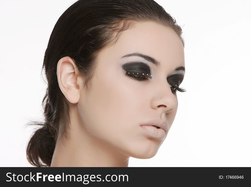 Studio portrait of young beautiful woman with bright eye makeup. Studio portrait of young beautiful woman with bright eye makeup