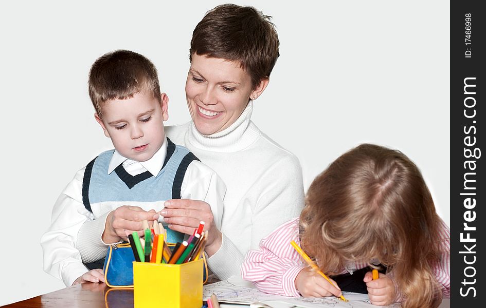 Mother and children together paint an album and have fun together