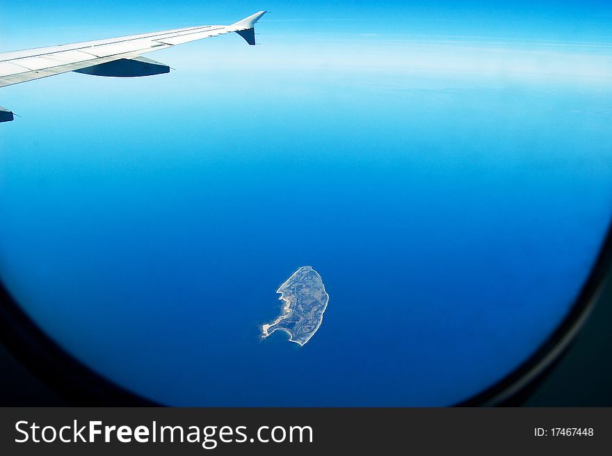 View of an island from the window of a plane. View of an island from the window of a plane