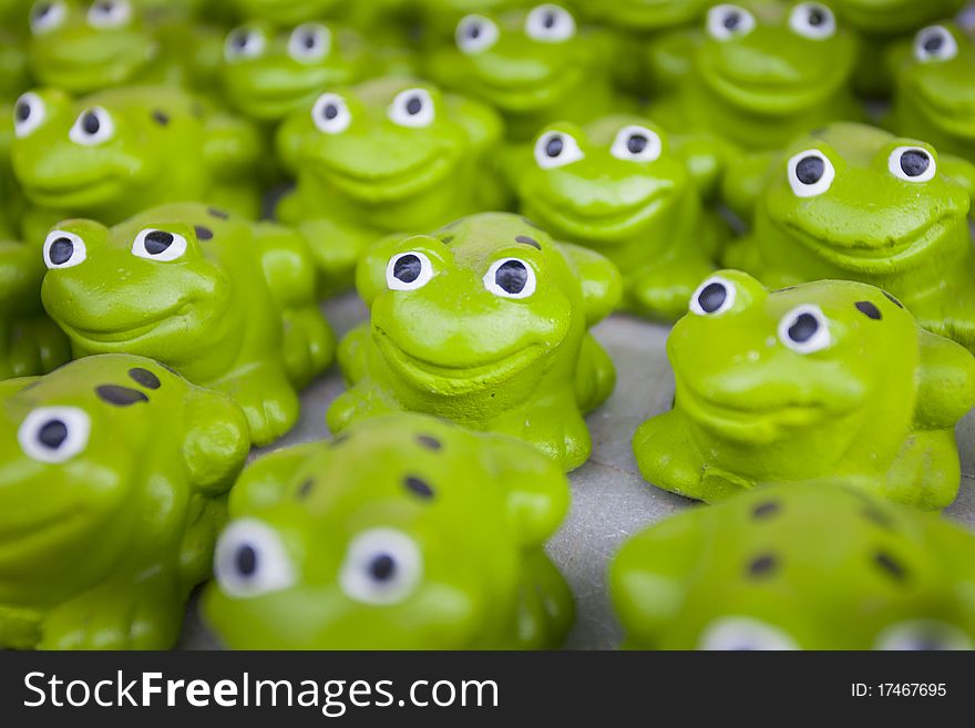 Many green ceramic smile frogs. Many green ceramic smile frogs