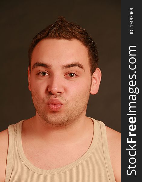 Portrait of a young man, Studio. Part of a grimace series, same model, different emotions.