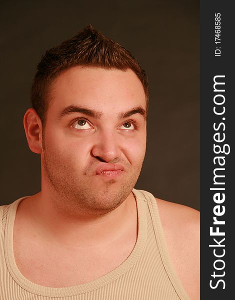 Portrait of a young man, Studio. Part of a grimace series, same model, different emotions.