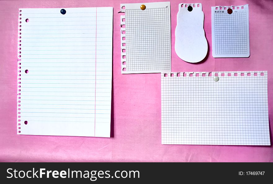 White sheets on the pink bulletin board. White sheets on the pink bulletin board