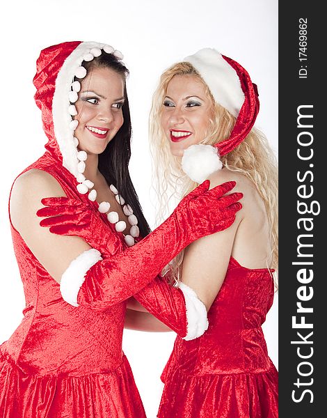 Two girls dressed as Santa's Helpers have fun on a Christmas party. Two girls dressed as Santa's Helpers have fun on a Christmas party