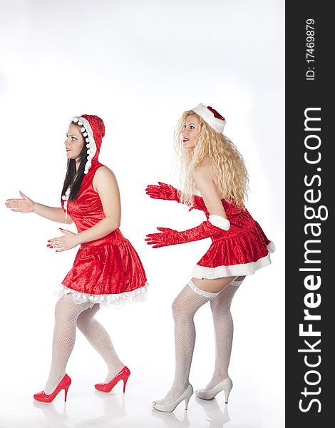 Two girls dressed as Santa's Helpers have fun on a Christmas party. Two girls dressed as Santa's Helpers have fun on a Christmas party