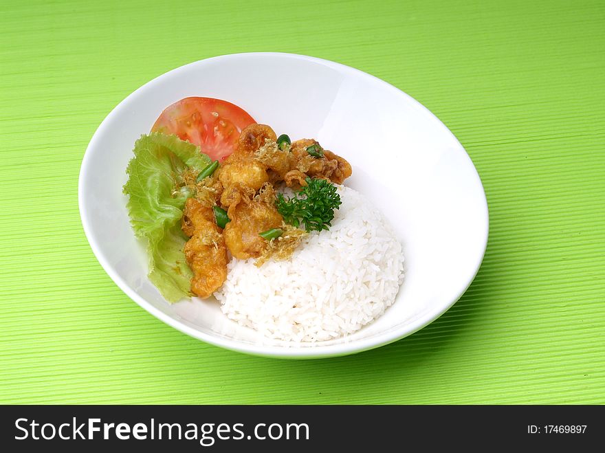 Rice and fried meat served on plate for dinner. Rice and fried meat served on plate for dinner