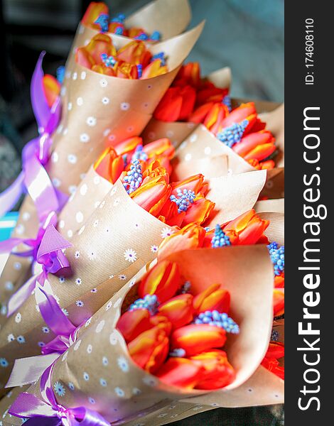 Many beautiful orange tulips bouquet in wrapping paper with ribbon. Many beautiful orange tulips bouquet in wrapping paper with ribbon
