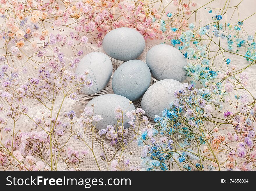 Hand painted Easter eggs on a background of multicolored pastel flowers. Happy Easter. Set of Easter eggs with a multicolored flowers on a white background. Spring holiday