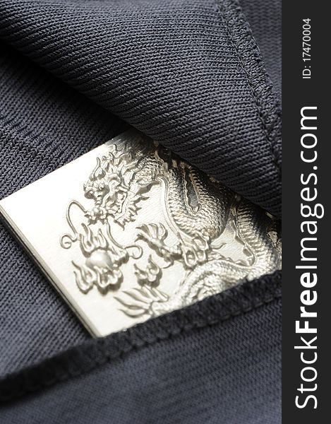 An engraving dragon plate hiding in a black cloth. An engraving dragon plate hiding in a black cloth.