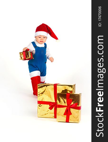 Little boy in Santa hat with a bunch of gifts