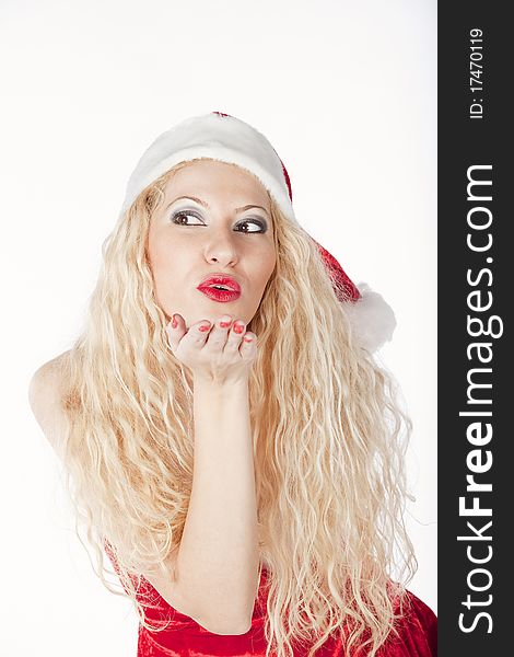 Sexy blonde girl dressed as Santa blowing a kiss