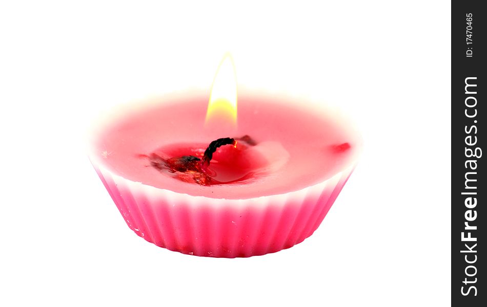 A burning pink candle isolated on white background