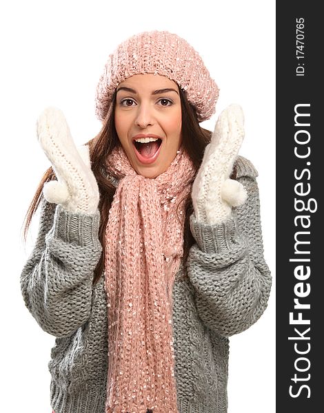 Surprised expression from a beautiful young woman with big happy laugh wrapped up warm in winter woollies, including mits, hat, scarf and jumper. Surprised expression from a beautiful young woman with big happy laugh wrapped up warm in winter woollies, including mits, hat, scarf and jumper.
