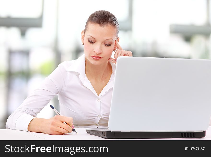 Portrait of an adorable business woman working at her desk