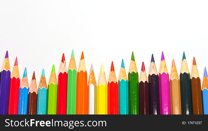 Color pencils in arrange in color wheel colors on white background. Color pencils in arrange in color wheel colors on white background