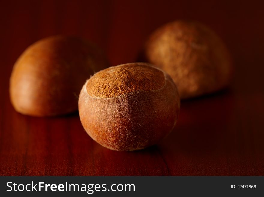 Chestnuts on wooden table. Shallow depth of field.