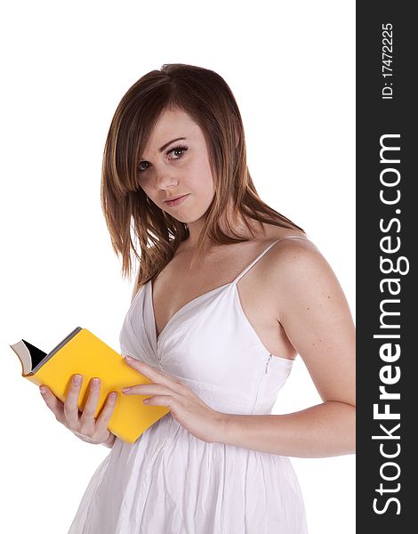 A woman looking up as she holds her yellow book open. A woman looking up as she holds her yellow book open.