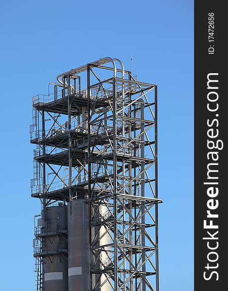 Tower structure in an oil refinery over blue sky. Tower structure in an oil refinery over blue sky