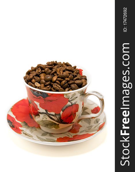 Cup with coffee beans isolated on white background