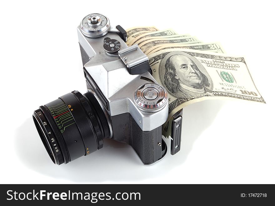 Money in the old camera on a white background. Money in the old camera on a white background