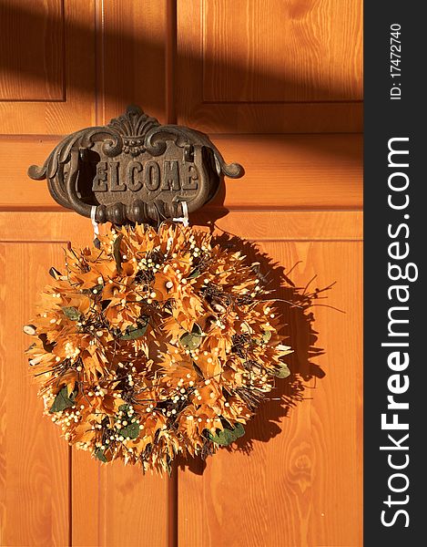 Wooden door of home, welcome sign with knocker. Wooden door of home, welcome sign with knocker