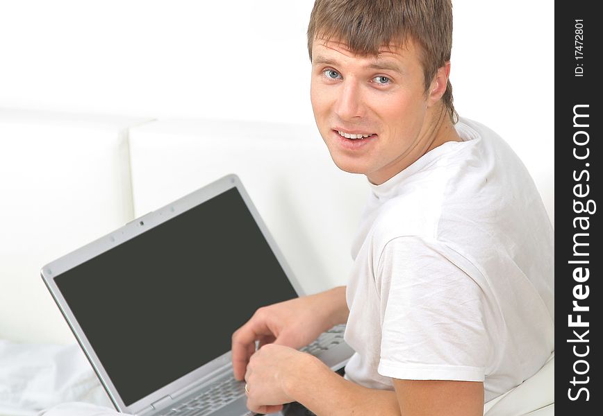 Rear view closeup of a young man working of a laptop