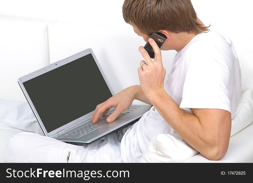 Rear view closeup of a young man working of a laptop