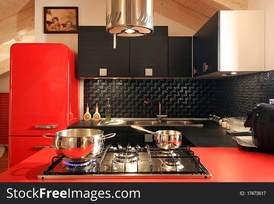 Modern mansard with red kitchen