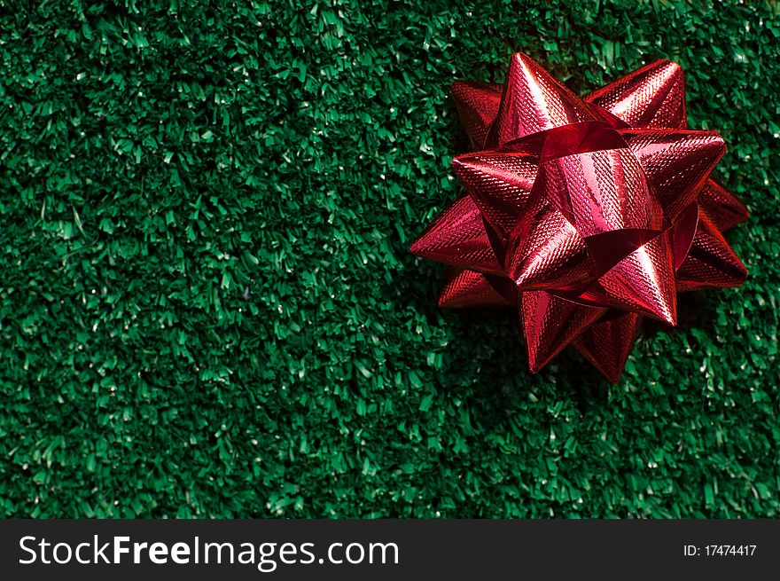 Red Gift Bow on green grass background