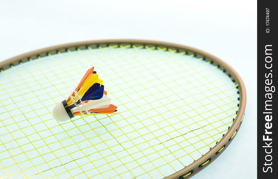 A mini colorfull shuttlecork on a badminton racquet