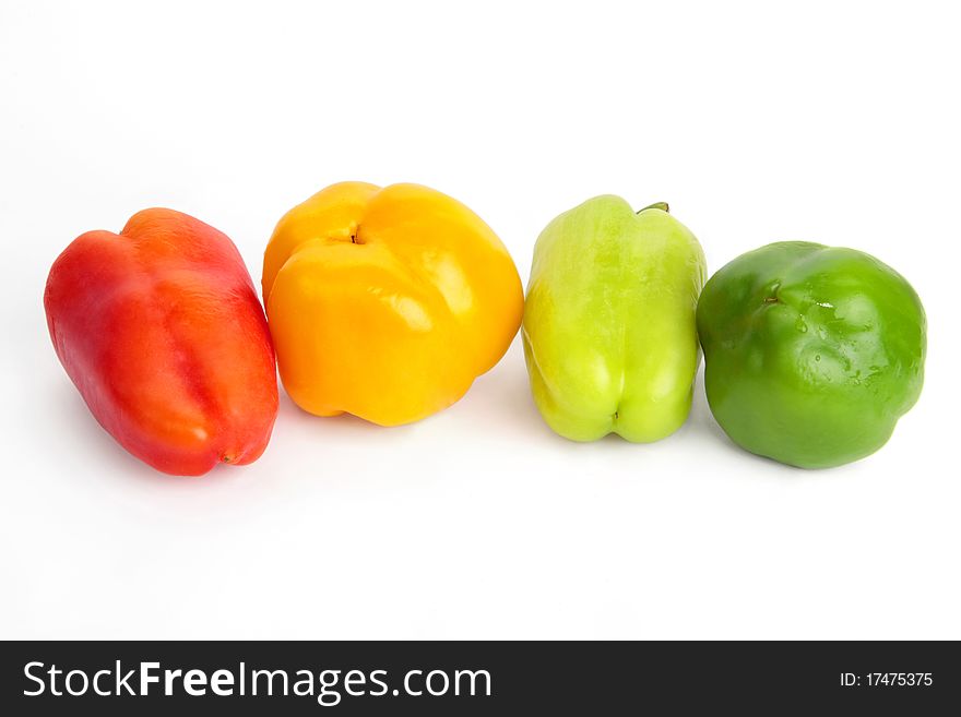 four fresh colorful peppers. Bulgarian peppers on a white background. four fresh colorful peppers. Bulgarian peppers on a white background.
