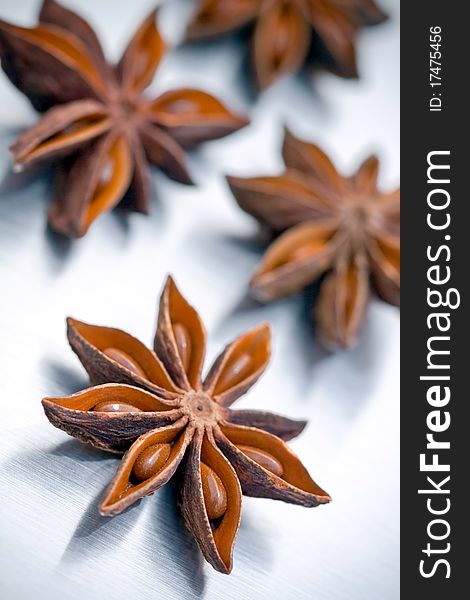 Star anise on grey brushed metal background (low DOF)