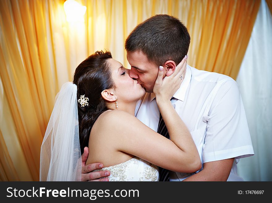 Romantic kiss happy bride and groom on wedding day